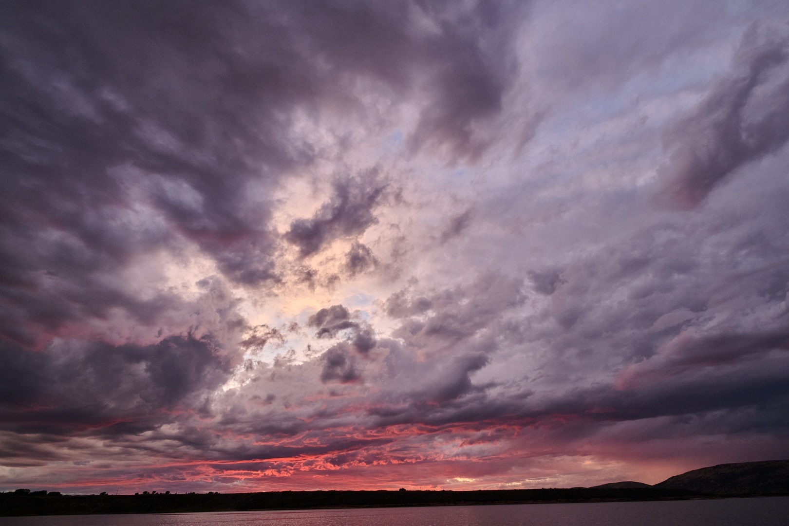 crazy pink sunset over a lake