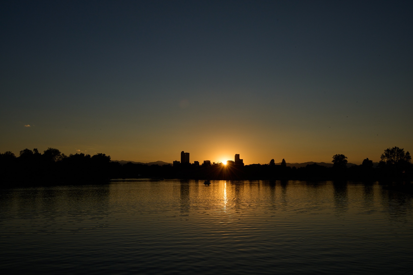 sunset over water in city park, denver, colorado