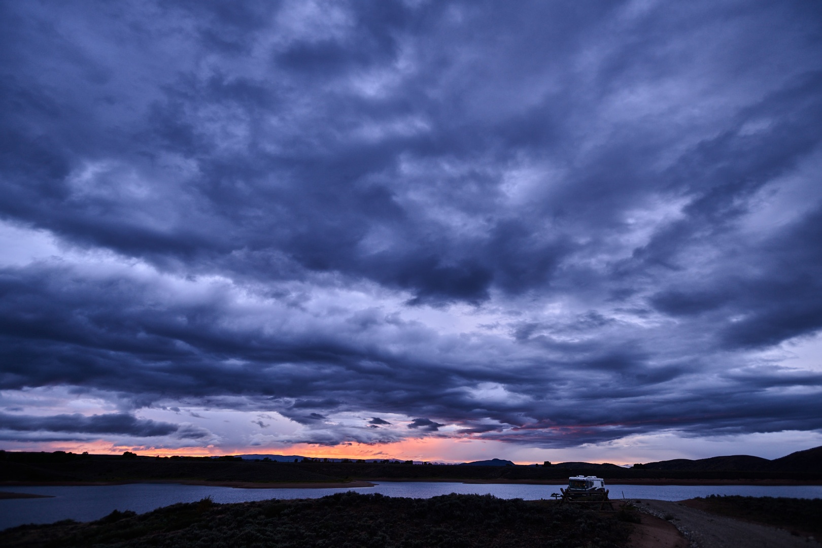 sunset with a camper van in the corner