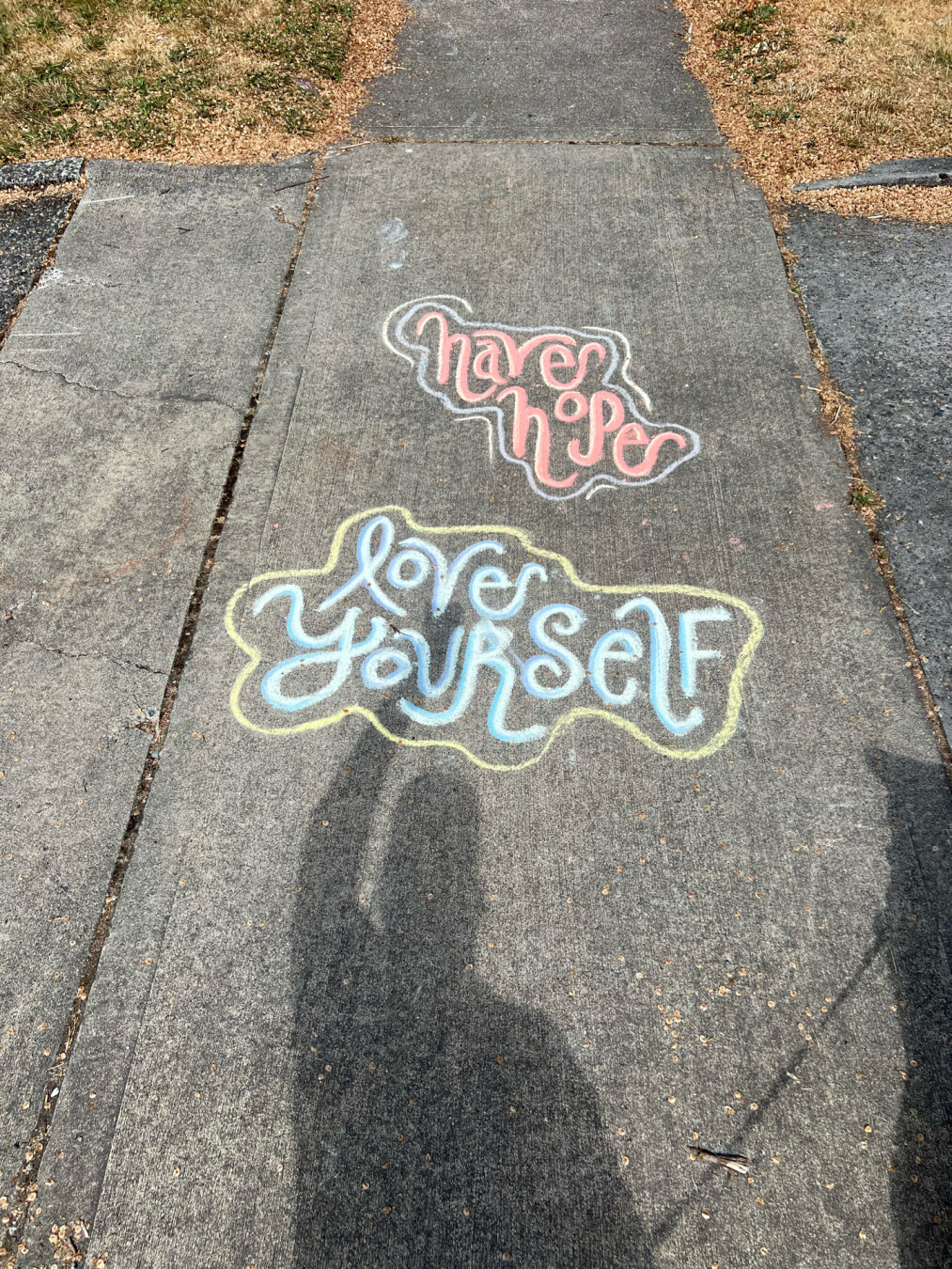 Sidewalk chalk art that says have hope love yourself