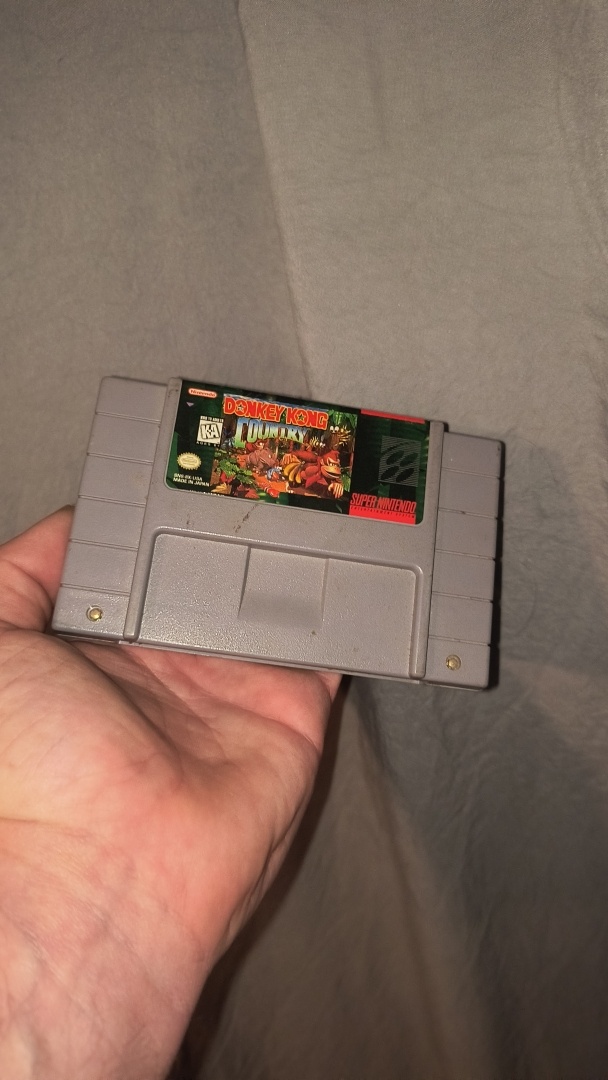 Donkey Kong Country for SNES in hand